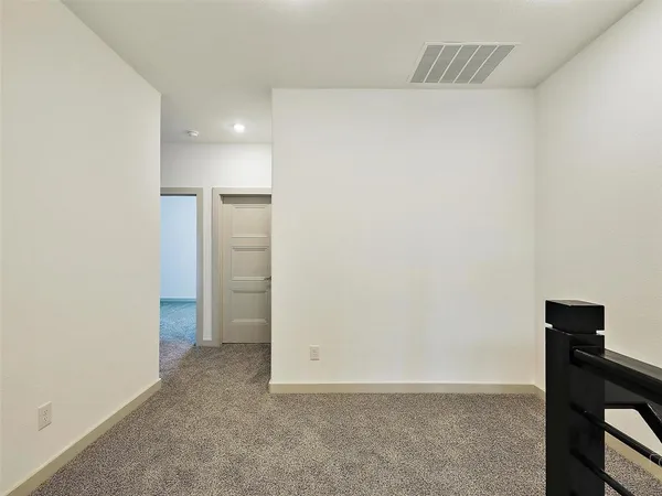 a view of an empty room with a bathroom