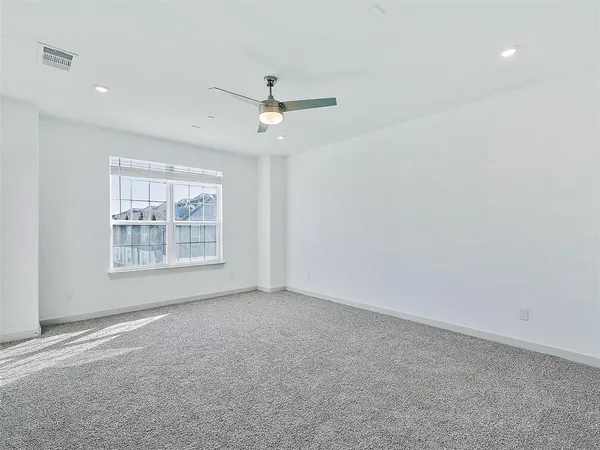 an empty room with closet and windows