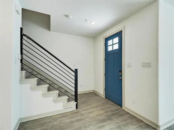 a view of entryway and hall with wooden floor