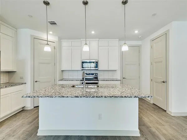 a bathroom with a granite countertop sink a mirror and a shower