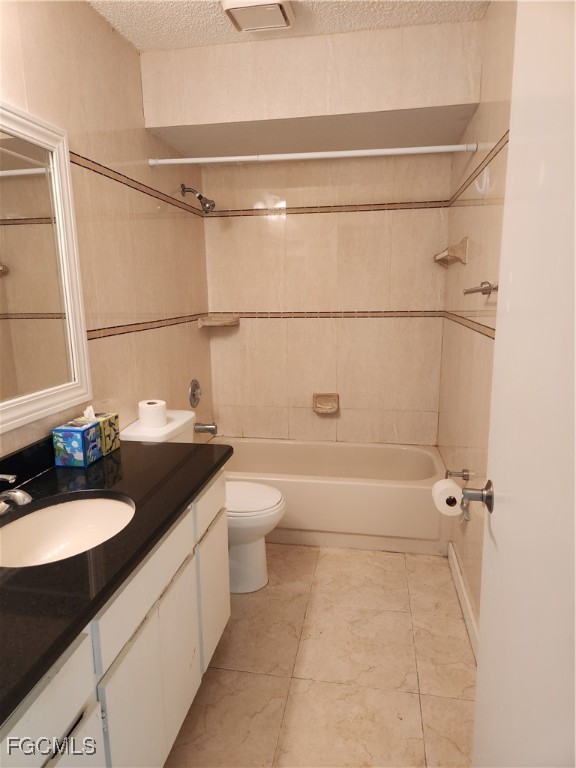 1420 Academy Boulevard, Unit 106 Cape Coral, FL 33990 - Photo 11 of 21 a bathroom with a granite countertop sink a toilet and shower