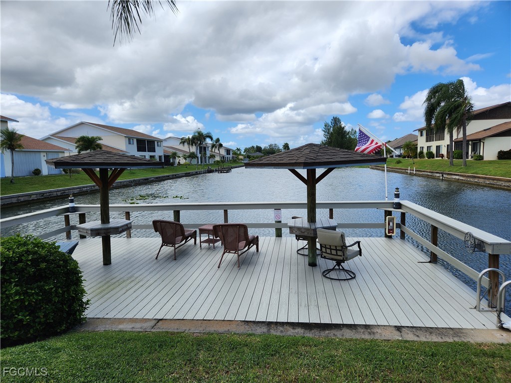 1420 Academy Boulevard, Unit 106 Cape Coral, FL 33990 - Photo 3 of 21 a view of a lake with outdoor seating