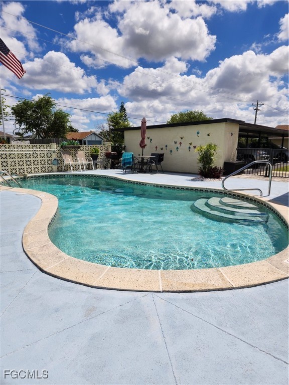 1420 Academy Boulevard, Unit 106 Cape Coral, FL 33990 - Photo 7 of 21 a view of a swimming pool with a yard