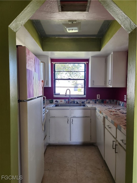 1420 Academy Boulevard, Unit 106 Cape Coral, FL 33990 - Photo 9 of 21 a kitchen with stainless steel appliances granite countertop a sink and a refrigerator