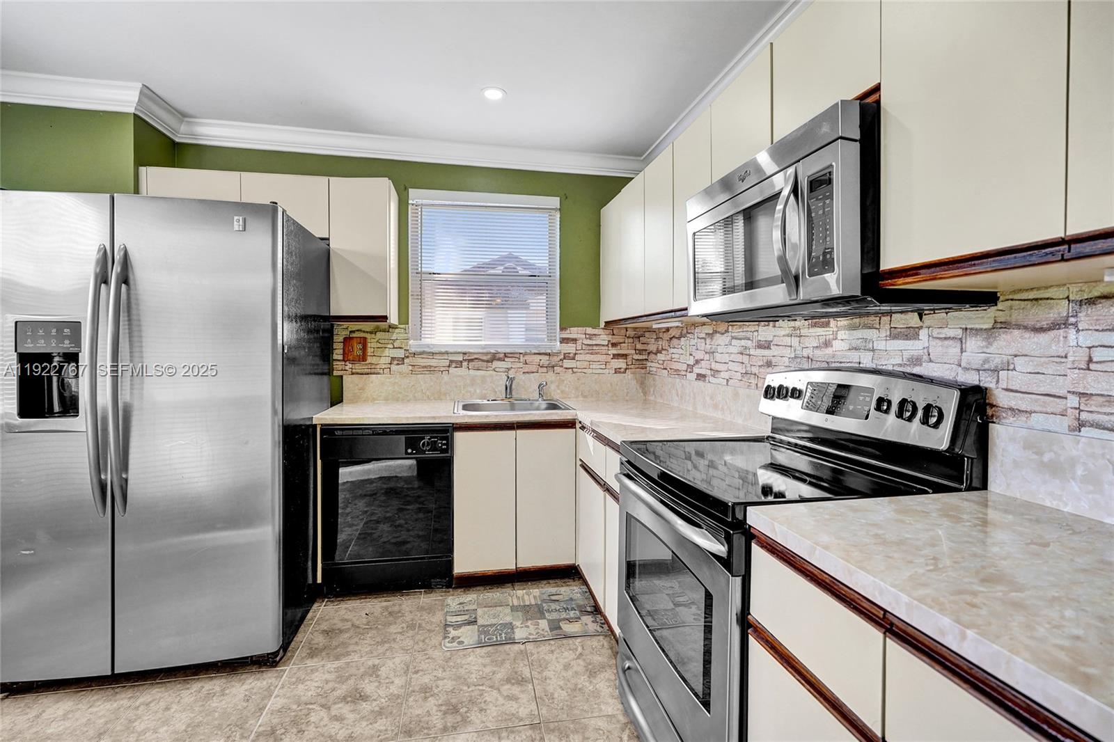 11201 Southwest 13th Street, Unit 204 Pembroke Pines, FL 33025 - Photo 12 of 33 a kitchen with stainless steel appliances granite countertop a sink stove and refrigerator