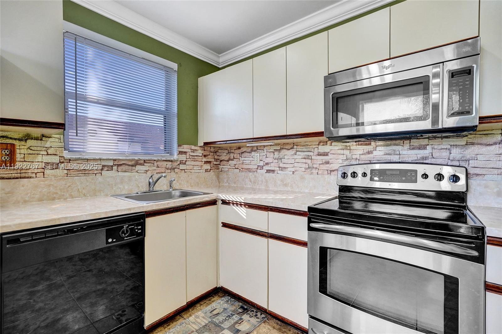 11201 Southwest 13th Street, Unit 204 Pembroke Pines, FL 33025 - Photo 16 of 33 a kitchen with a stove and a microwave
