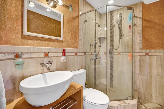 a bathroom with a sink toilet and shower