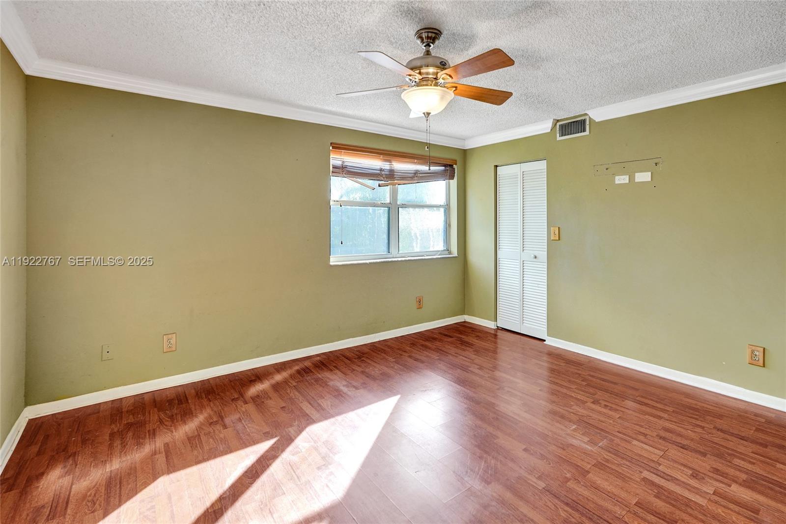 11201 Southwest 13th Street, Unit 204 Pembroke Pines, FL 33025 - Photo 25 of 33 an empty room with wooden floor and windows
