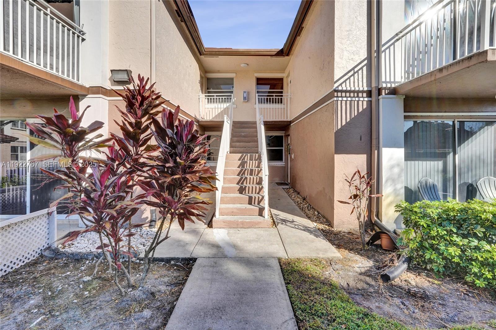 11201 Southwest 13th Street, Unit 204 Pembroke Pines, FL 33025 - Photo 4 of 33 a view of a house with a yard and potted plants