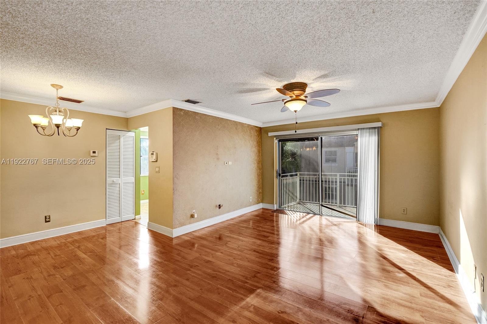 11201 Southwest 13th Street, Unit 204 Pembroke Pines, FL 33025 - Photo 8 of 33 an empty room with wooden floor and a ceiling fan