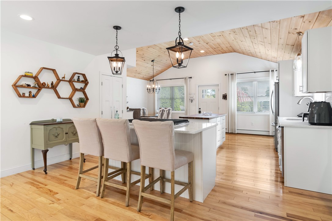 8 6th Street Warren, RI 02885 - Photo 11 of 41 The main focus of the home is the stunning kitchen with wood vaulted ceiling, hickory flooring, center island w/ butcher block counter top, and deep storage drawers offers amazing accessibility.