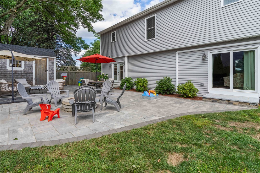8 6th Street Warren, RI 02885 - Photo 28 of 41 Fire pit, lovely manicured fenced yard, and storage shed with power.