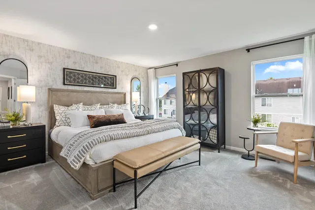 a spacious bedroom with a bed and a large window