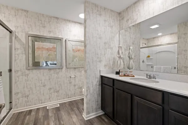 a bathroom with a sink a mirror and a shower
