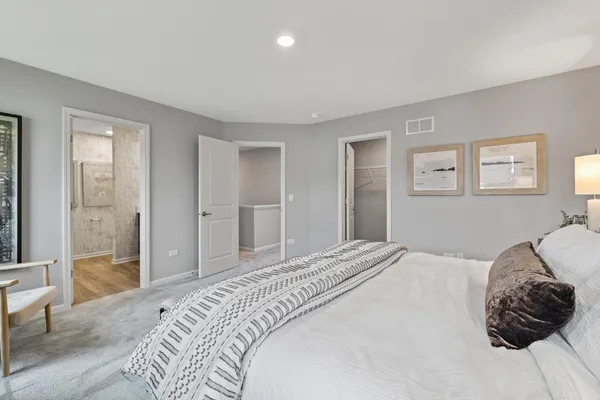 a bedroom with a bed and a couch