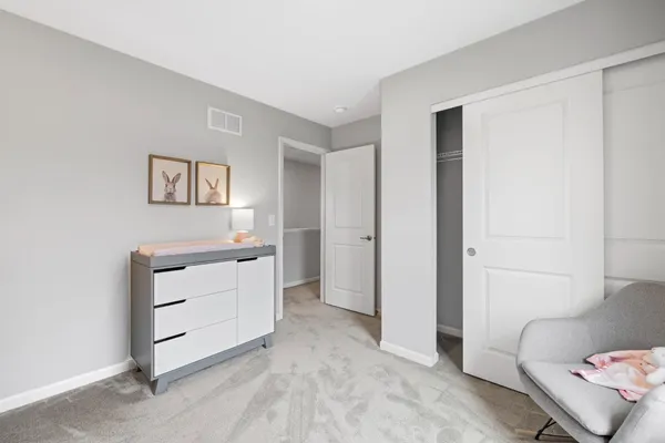 a bed room with a bed and a chair