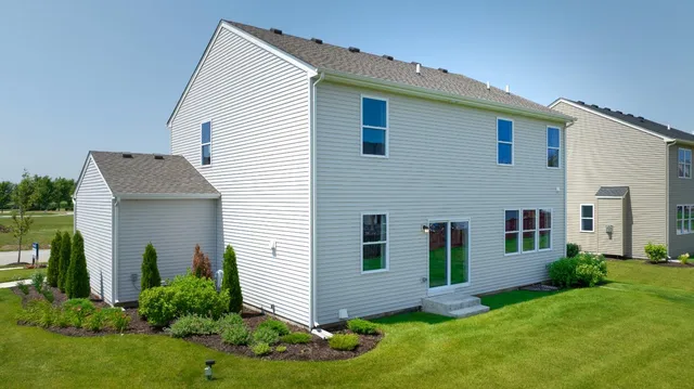 a view of a house with a yard and plants