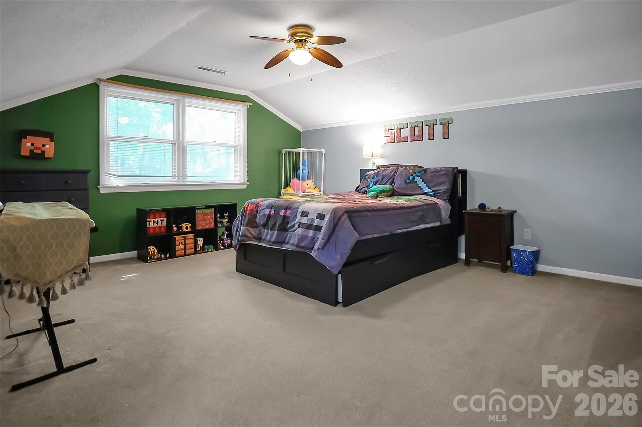 808 Old Mt Holly Road Stanley, NC 28164 - Photo 35 of 48 a spacious bedroom with a bed and a chandelier