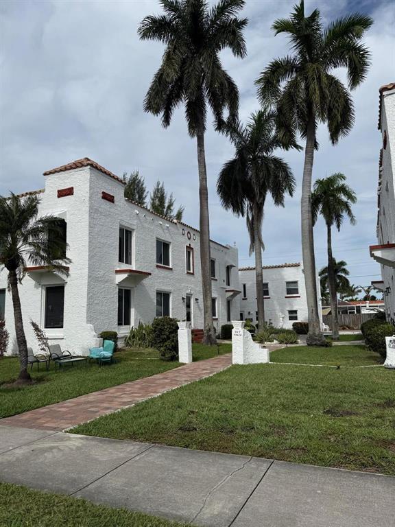 817 Tyler Street, Unit 2 Hollywood, FL 33019 - Photo 2 of 9 a front view of multiple houses with yard