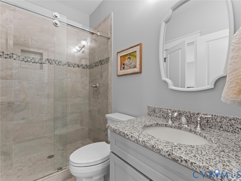 1925 Limbeck Lane Midlothian, VA 23112 - Photo 58 of 89 a bathroom with a granite countertop sink a toilet and shower