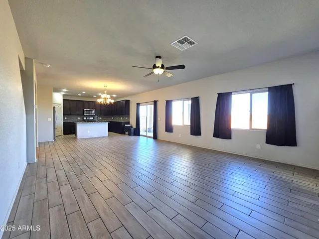 a spacious bedroom with a bed and a mirror