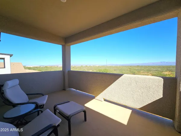 a view of a chairs and table in a balcony