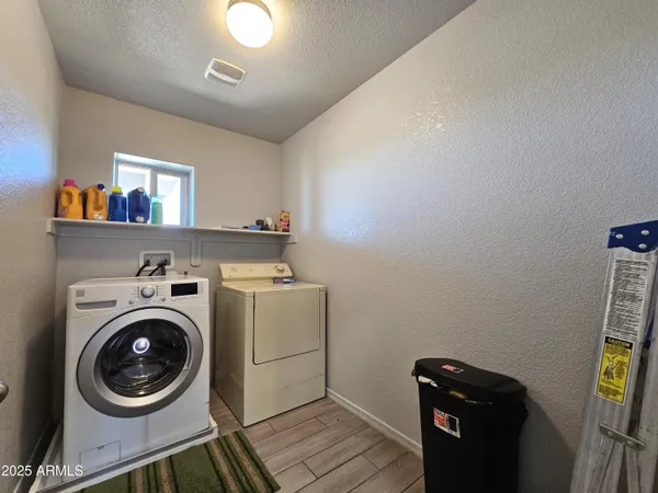 a bathroom with a granite countertop sink a toilet a large mirror and shower