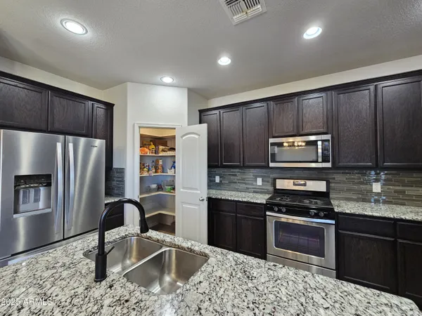 a kitchen with a sink and refrigerator
