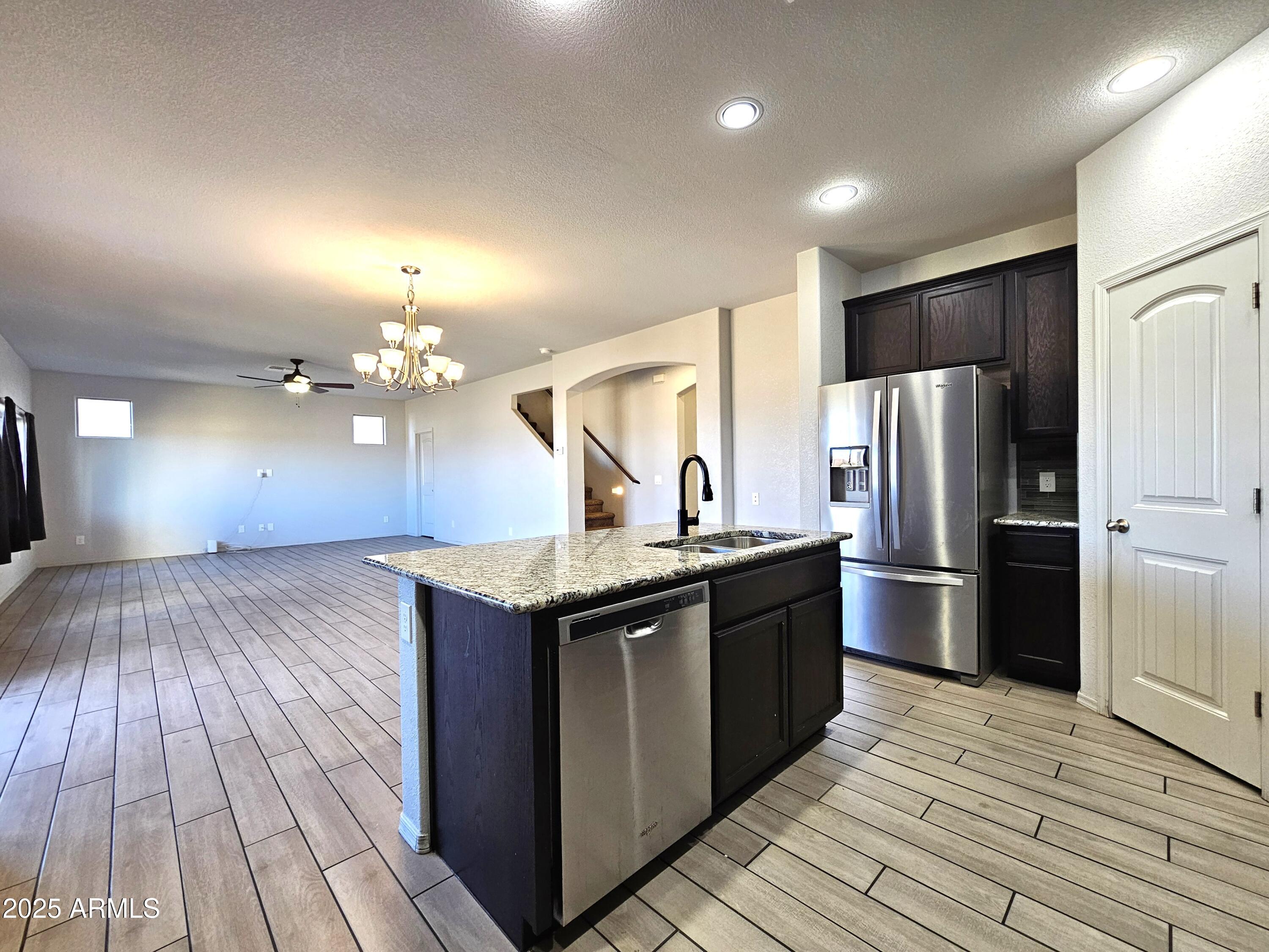 3443 Rhapsody Drive Sierra Vista, AZ 85650 - Photo 8 of 28 a kitchen with a sink and refrigerator
