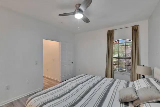 a bathroom with a granite countertop toilet a sink and a mirror
