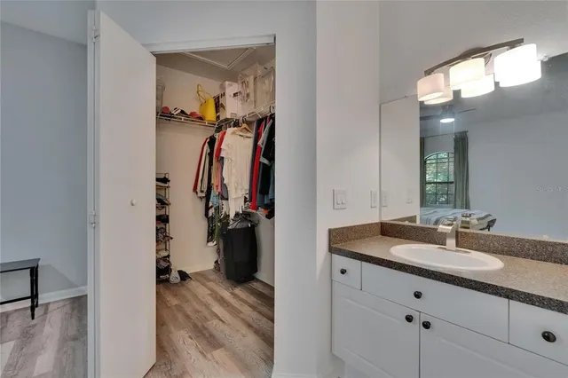 a bedroom with a bed and a large mirror