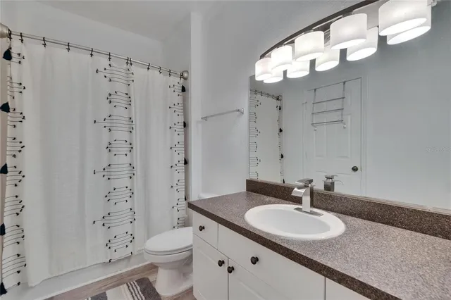 a white toilet sitting next to a bath tub