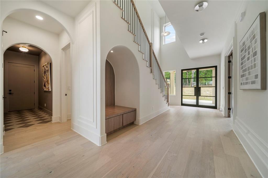 210 Simonton Road Southwest Lawrenceville, GA 30046 - Photo 11 of 55 a view of a hallway with entryway wooden floor and front door