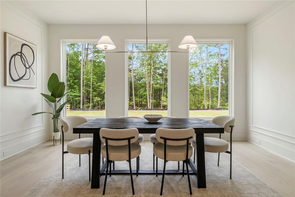 210 Simonton Road Southwest Lawrenceville, GA 30046 - Photo 23 of 55 a dining room with furniture a chandelier and wooden floor