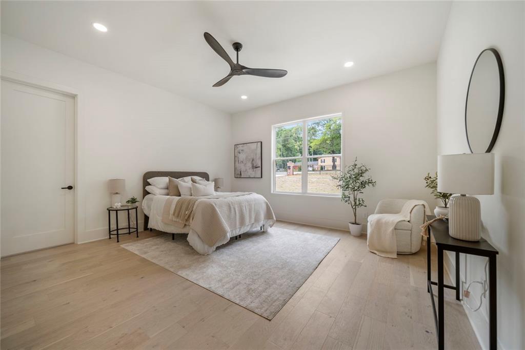210 Simonton Road Southwest Lawrenceville, GA 30046 - Photo 32 of 55 a spacious bedroom with a bed and a chandelier