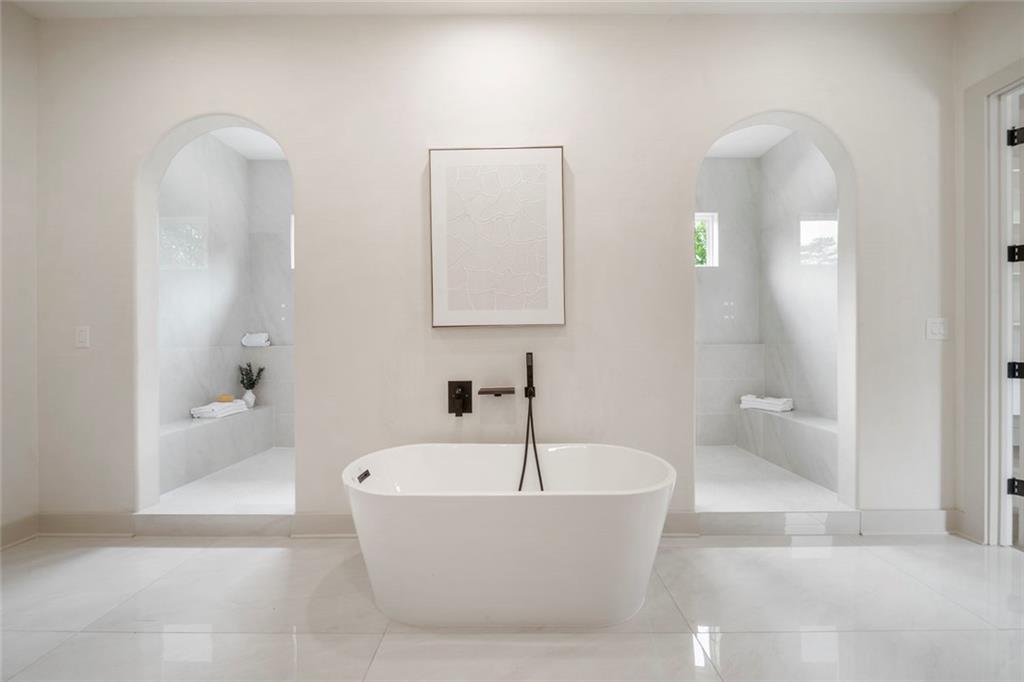 210 Simonton Road Southwest Lawrenceville, GA 30046 - Photo 48 of 55 a white bath tub sitting in a bathroom and mirror