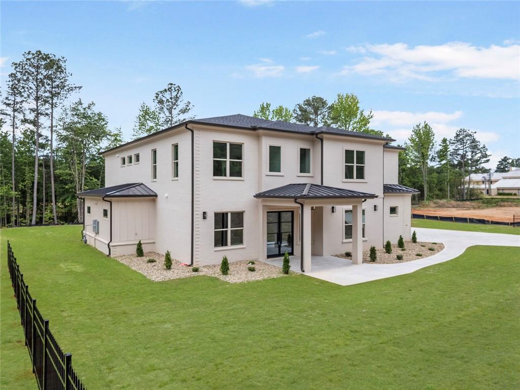 210 Simonton Road Southwest Lawrenceville, GA 30046 - Photo 5 of 55 a white house that has a big yard in front of it