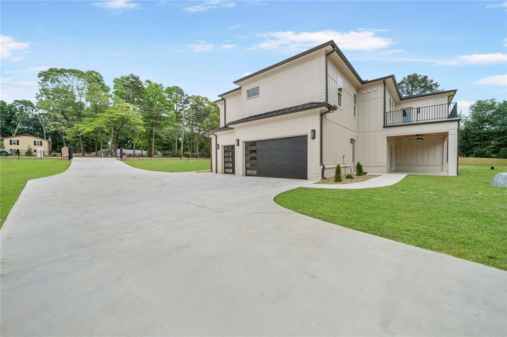 210 Simonton Road Southwest Lawrenceville, GA 30046 - Photo 53 of 55 a view of a house with a yard and garage