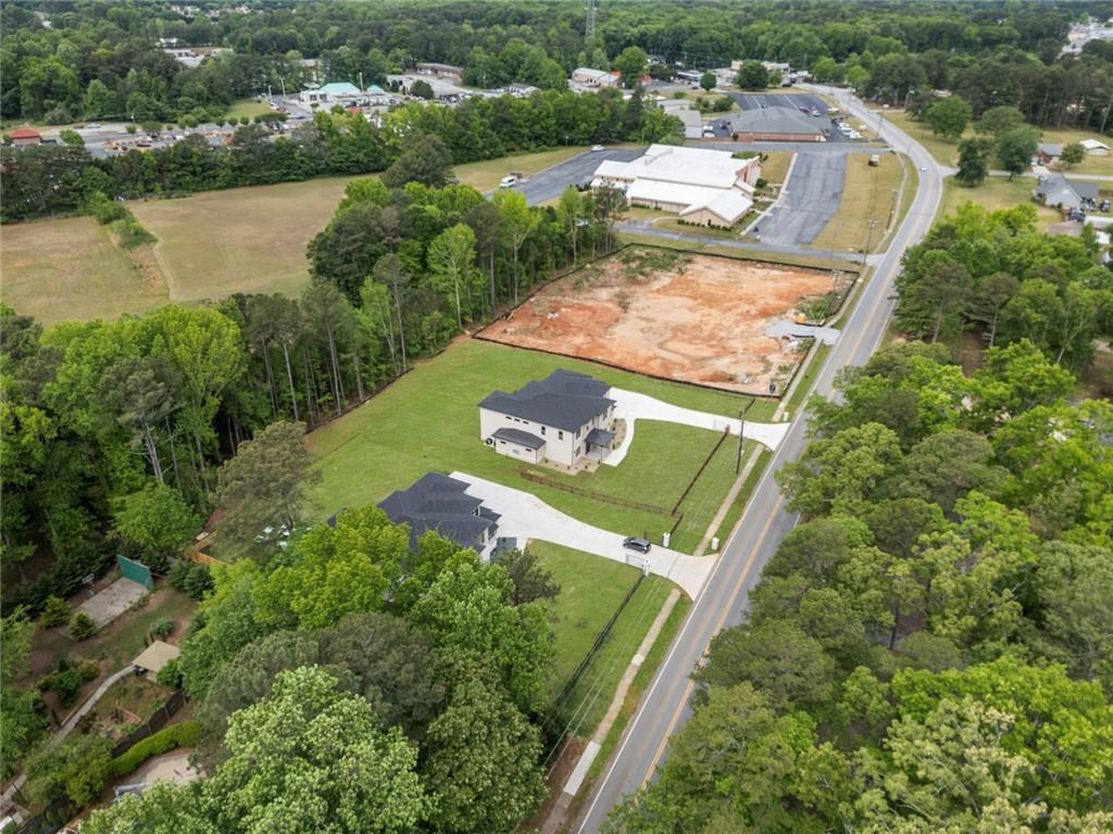 210 Simonton Road Southwest Lawrenceville, GA 30046 - Photo 8 of 55 an aerial view of residential houses with outdoor space and lake view