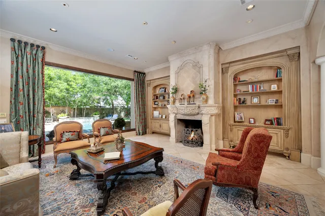 a living room with furniture a fireplace and a large window