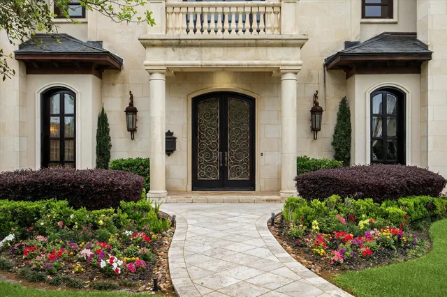 a view of a patio with table and chairs potted plants and a large tree