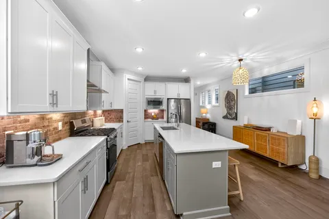 a kitchen with a sink a counter top space and appliances
