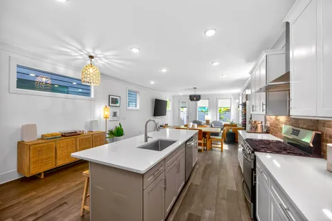 a kitchen with a sink a counter top space and stainless steel appliances