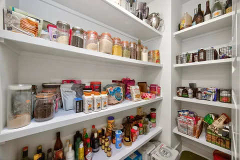 a store room with lots of clutter and cabinets