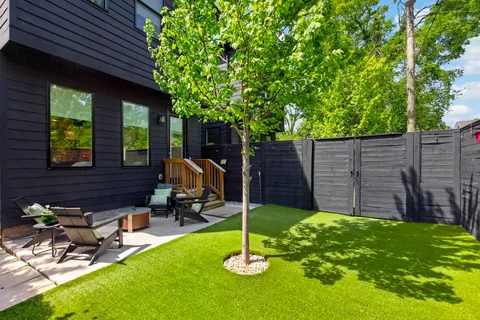 a backyard of a house with table and chairs