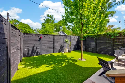 a view of a backyard with a small cabin and chair