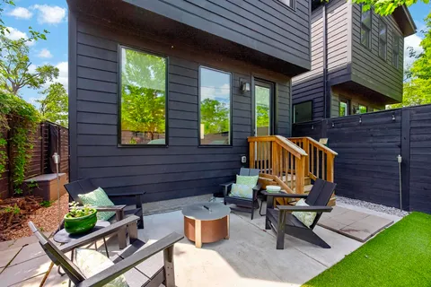 a view of an outdoor sitting area with brick walls