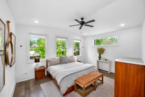 a bedroom with a bed a window and a chandelier
