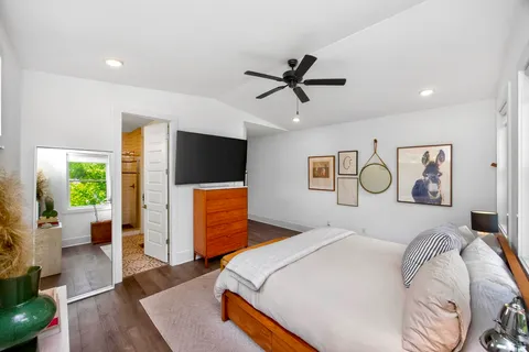 a bedroom with a bed and a flat screen tv