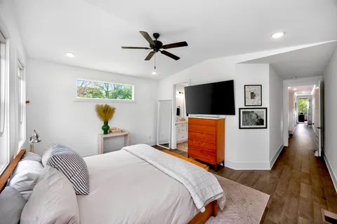 a bedroom with a bed and a flat screen tv